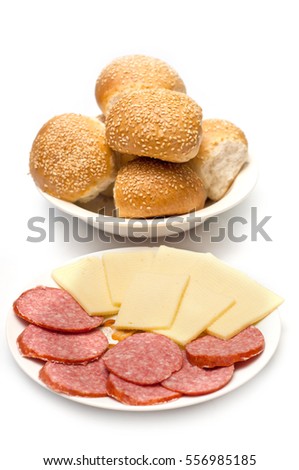 Bread rolls sausage and cheese on white background