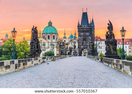 Prague, Czech Republic. Charles Bridge (Karluv Most) and Old Town Tower at sunrise. Royalty-Free Stock Photo #557010367