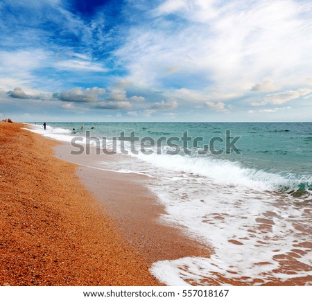 beautiful sunny sandy beach on the Mediterranean Sea and the heavenly light landscape with clouds