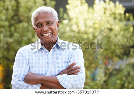 Smiling senior African American man with arms crossed Royalty-Free Stock Photo #557019079
