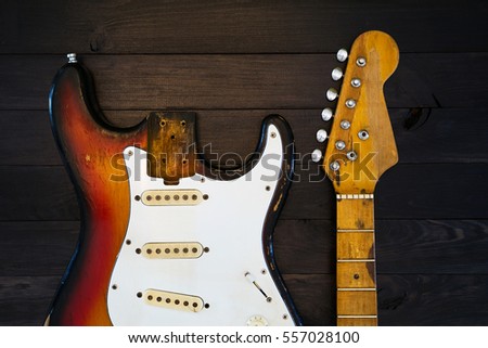 Vintage guitar parts on dark wooden background