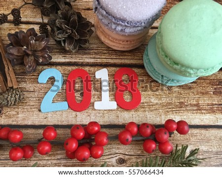 2018. 2018 wooden date with macarroons, cones and red berries. Christmas 2018