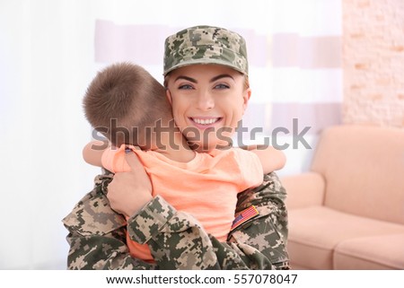 Mother soldier and little kid in the room
