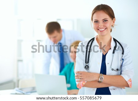 Attractive female doctor in front of medical group Royalty-Free Stock Photo #557085679