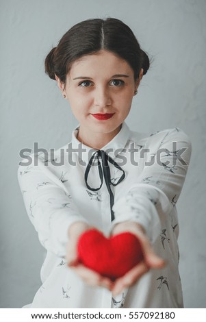 Girl holding heart on Valentine's day. White background.