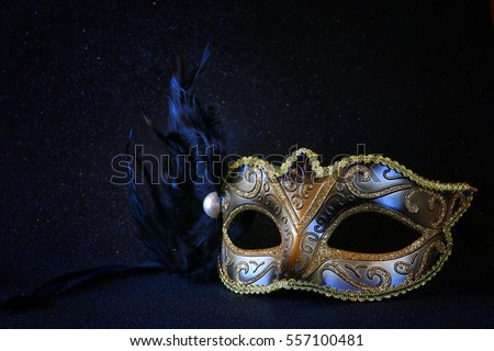 Image of black elegant venetian mask on glitter background