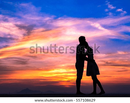 Silhouette of Happy Young Couple love Outside at Sunset