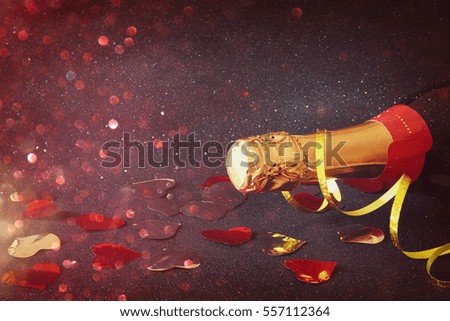 Abstract image of champagne bottle and festive lights. New year and celebration concept