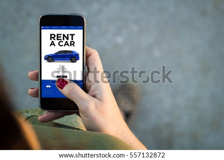 Top view of woman walking in the street using her mobile phone to rent a car with copy space. All screen graphics are made up.