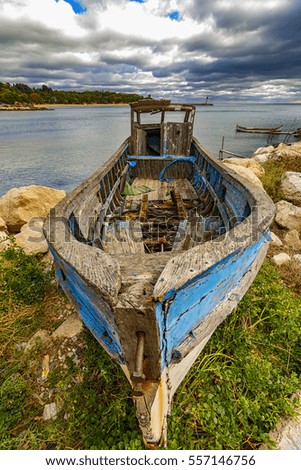 Abandoned old wooden fishing boat on the beach