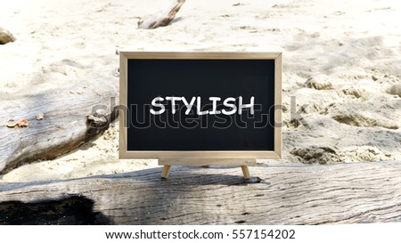 Blackboard on a tree trunk with the words "STRONG". Background beach sand.motivation concept.