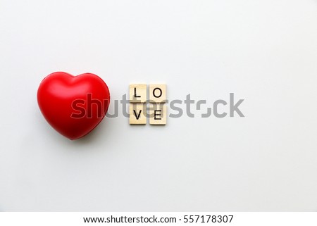 I LOVE YOU text word made with wood blocks and Red Heart on table.Valentine Concept.