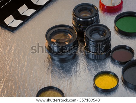 Clapperboard, lenses and filters on the table