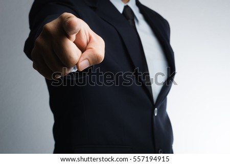 Business man aggressive pointing index finger on white background Royalty-Free Stock Photo #557194915