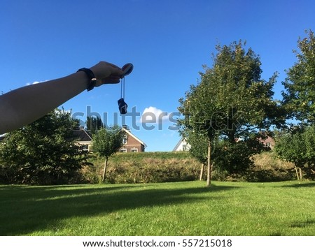 Holding a keyring, a trackable, geocaching