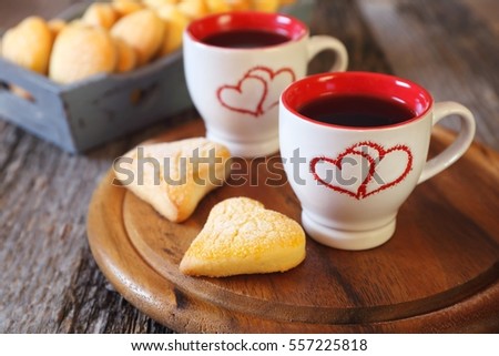 Valentine's Day: two cups of coffee and heart cookies in wooden tray. Toned image