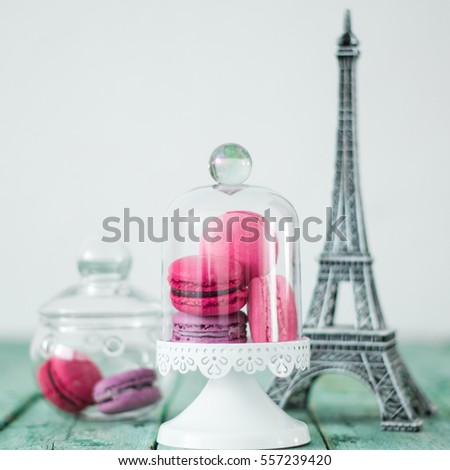Macaroons traditional Parisian cookie and Eiffel tower on wooden table