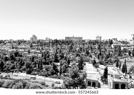 View from top of ancient walls surrounding Old City in Jerusalem. View on the landmarks of Jerusalem Old City. Black and White Picture