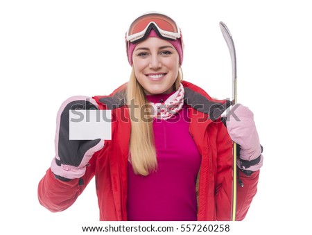 Attractive girl skier shows a white card.