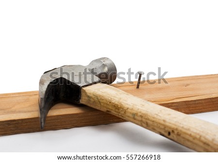 Hammer and Rivet Hammered into a Wooden Piece, Isolated on White Background