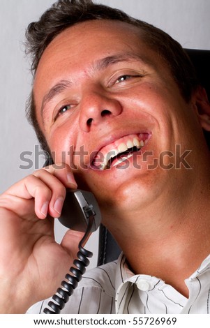 A laughing man on telephone