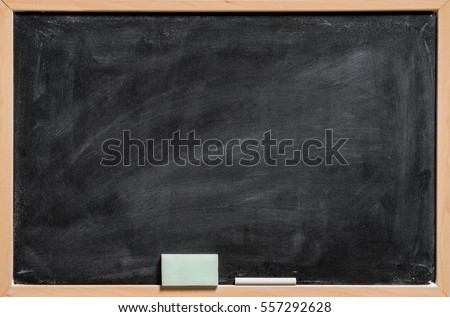 Blank Blackboard Background. Chalk and eraser on the frame Royalty-Free Stock Photo #557292628