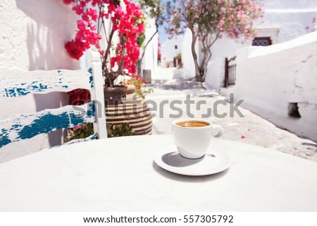 Traditional greek coffee in a cafe with beautiful mediterranean street on the background