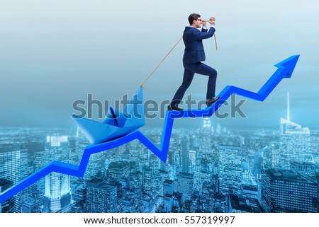 Businessman pulling boat over line chart