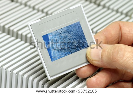 Hand holding a plastic picture slide frame.