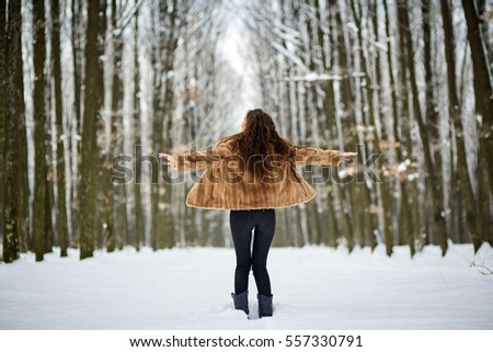 Full length of an attractive young woman in snow outdoor