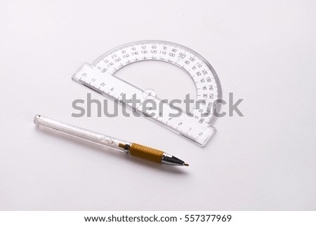 Pen and protractor on white background