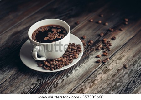 coffee beans, black background, cup, saucer
