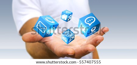 Young businessman connecting modern cube interface in his hand