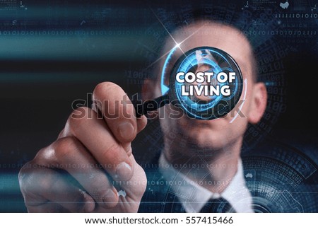 Business, Technology, Internet and network concept. Young businessman working on a virtual screen of the future and sees the inscription: cost of living 