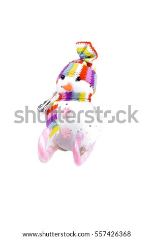 Toy snowman on skis from a pink candy striped on a white background. Christmas souvenir.