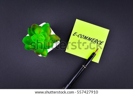 Green sticky note with pen with text E-COMMERCE