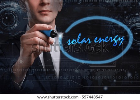 Business, Technology, Internet and network concept. Young business man writing word: solar energy 