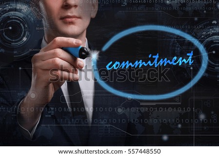 Business, Technology, Internet and network concept. Young business man writing word: commitment