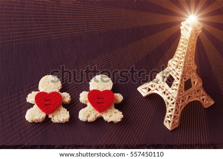 Romantic background. Postcard for Valentine's day. The Eiffel tower, and two hearts. Human figures made of bread.