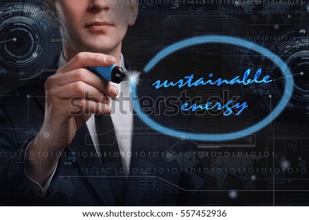 Business, Technology, Internet and network concept. Young business man writing word: sustainable energy 