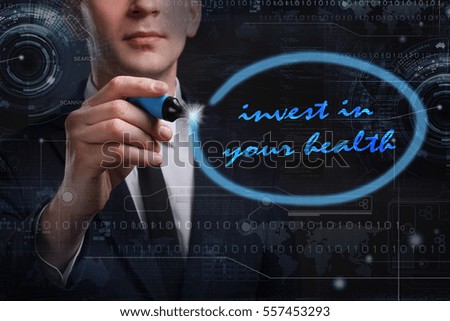 Business, Technology, Internet and network concept. Young business man writing word: invest in your health 