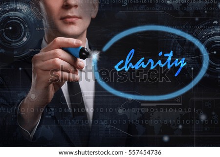 Business, Technology, Internet and network concept. Young business man writing word: charity