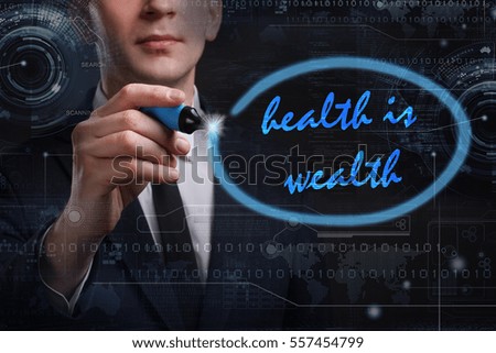 Business, Technology, Internet and network concept. Young business man writing word: health is wealth 