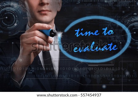 Business, Technology, Internet and network concept. Young business man writing word: time to evaluate
