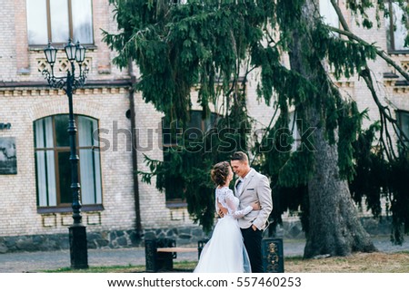 Young wedding couple near the old building 