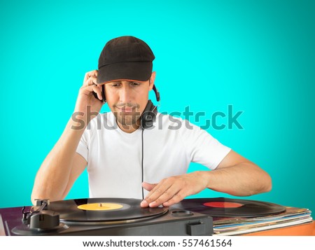 DJ mixing vinyl record on a  turntable with green background