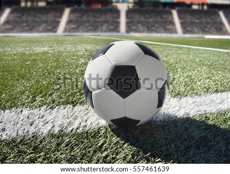 shot of a traditional soccer ball soccer on soccer field with stadium background