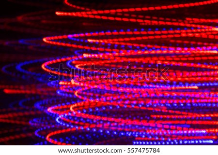 Defocus lights bokeh motion blur abstract background. Bright red and blue colors.