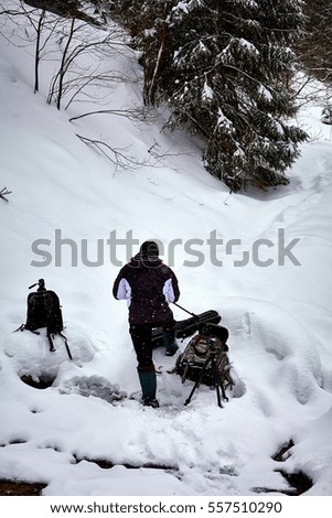 Professional nature photographer outdoor in the mountain winter landscape