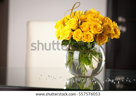 Yellow roses in vase on the table. Holidays and celebration concept